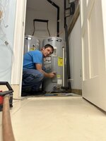 Dr. Plumber in front of a water heater